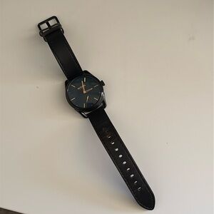 Black and gold Nixon C39 leather watch